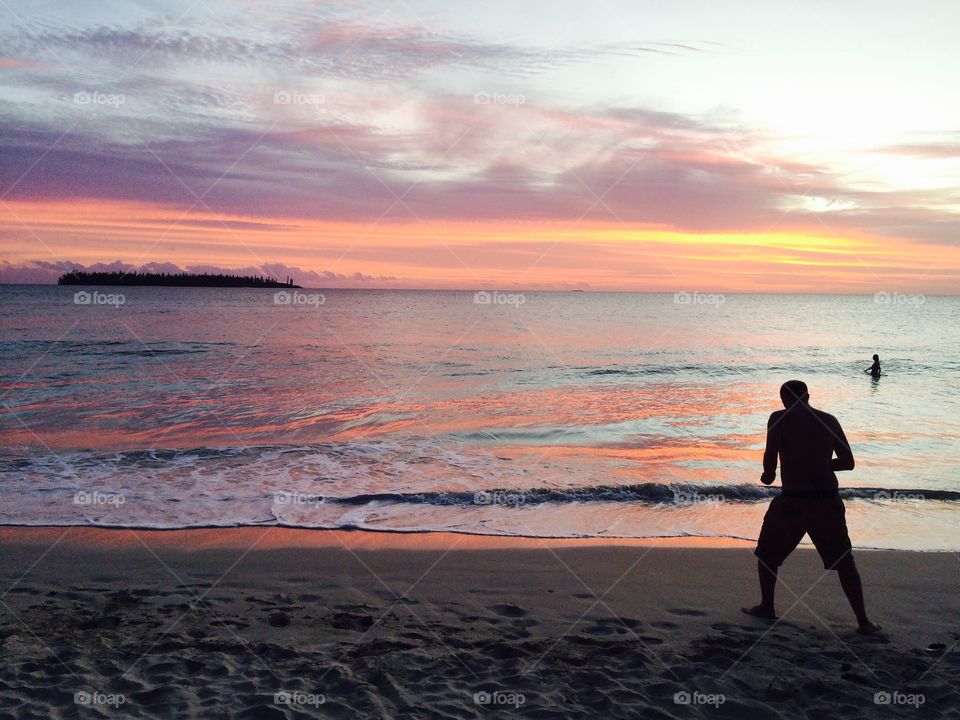 Paradise Island sun set in the beach with man