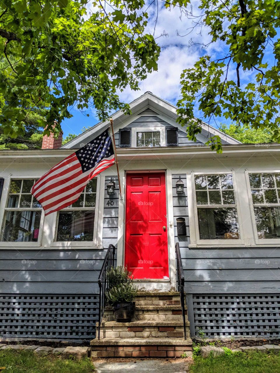 home with an American flag on a sunny day