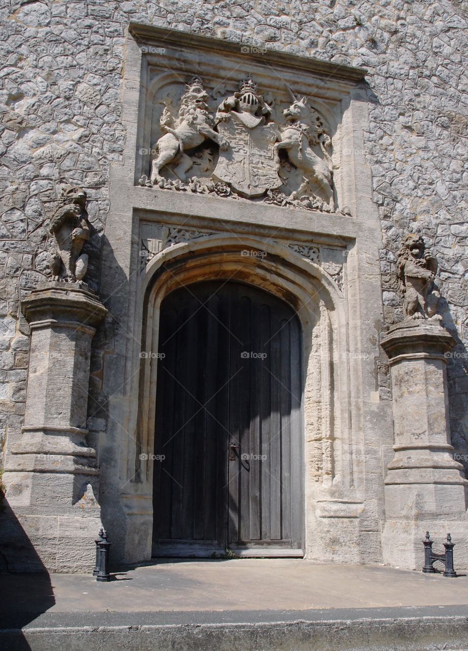 An ornamental archway over a door with pillars and statues cut from stone on an old building at the Dover Castle grounds in England. 