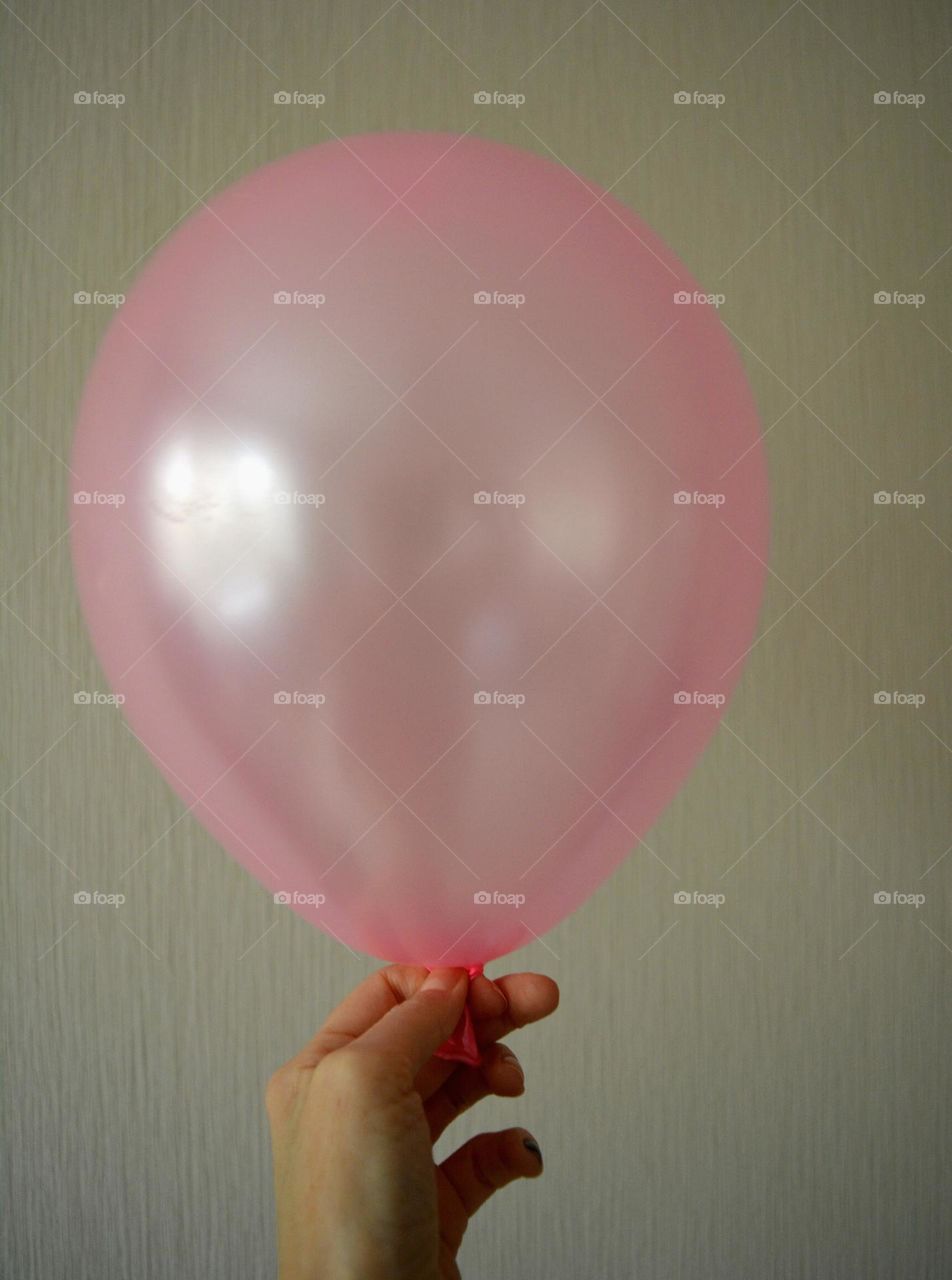 pink helium balloons in the hand