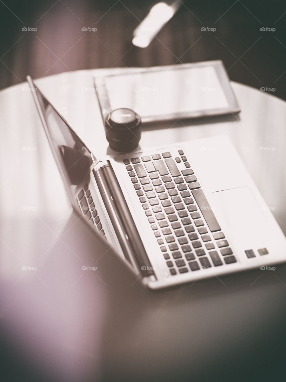 Modern photographer working tools. Laptop, tablet and lens