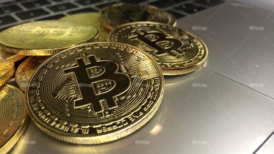 Close up on Gold bitcoin on keyboard 