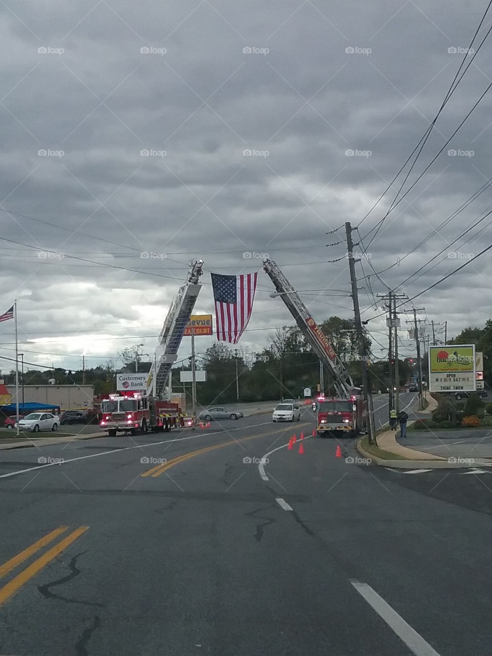 2 Firetrucks hanging the flag