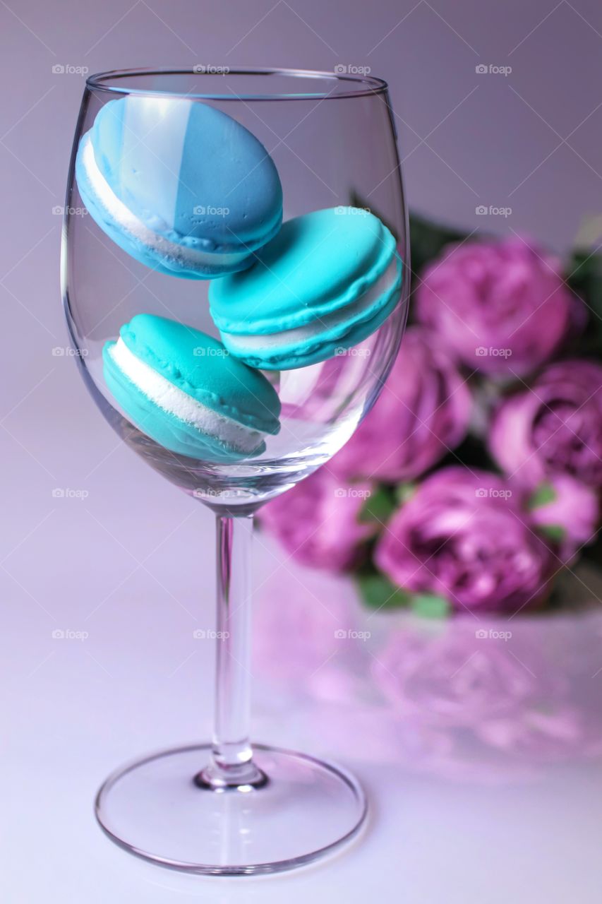 Three blue macaroons in the glass 