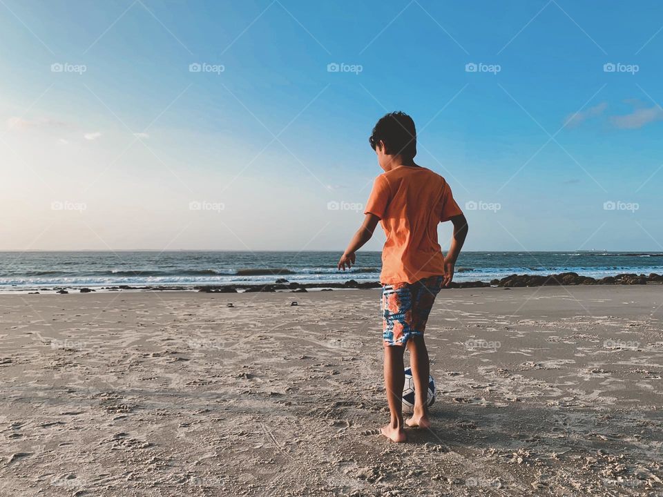 Young boy playing at the beach 