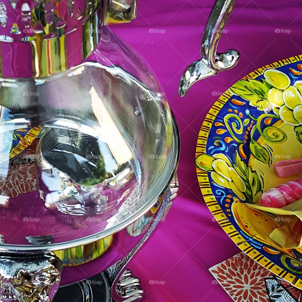 Reflections on a tea pot during high tea.