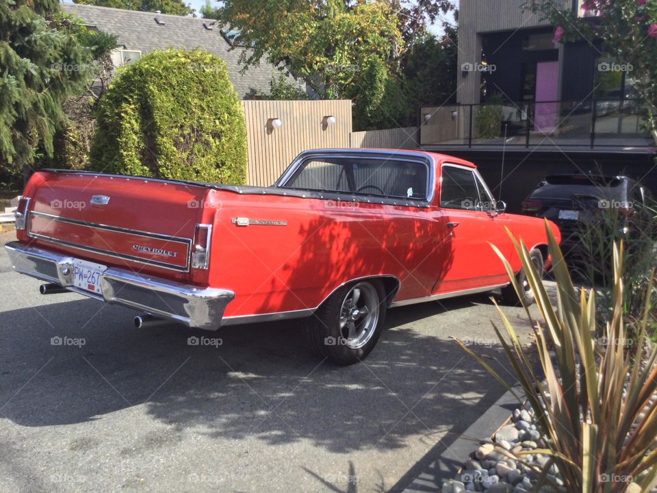 An Old Red El Camino in the Driveway 