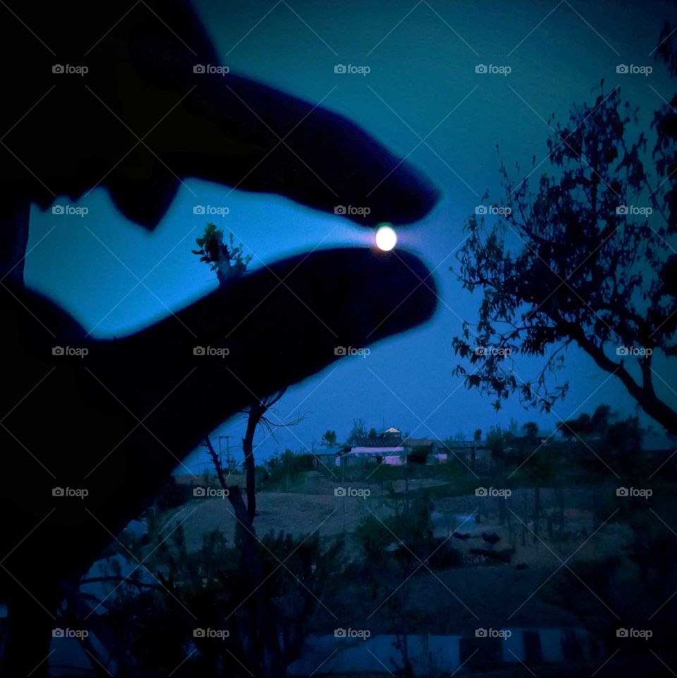 its night captured, and full moon in between two fingers, catching moon from earth, clear moon light like a sunny day, Nepal
