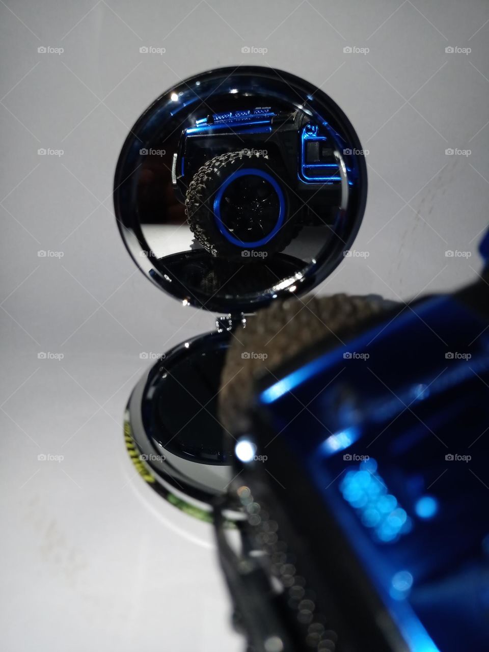 Reflection of a blue jeep in a mirror clousup view