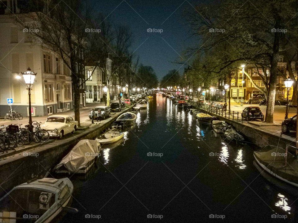 Night in Amsterdam with boats.