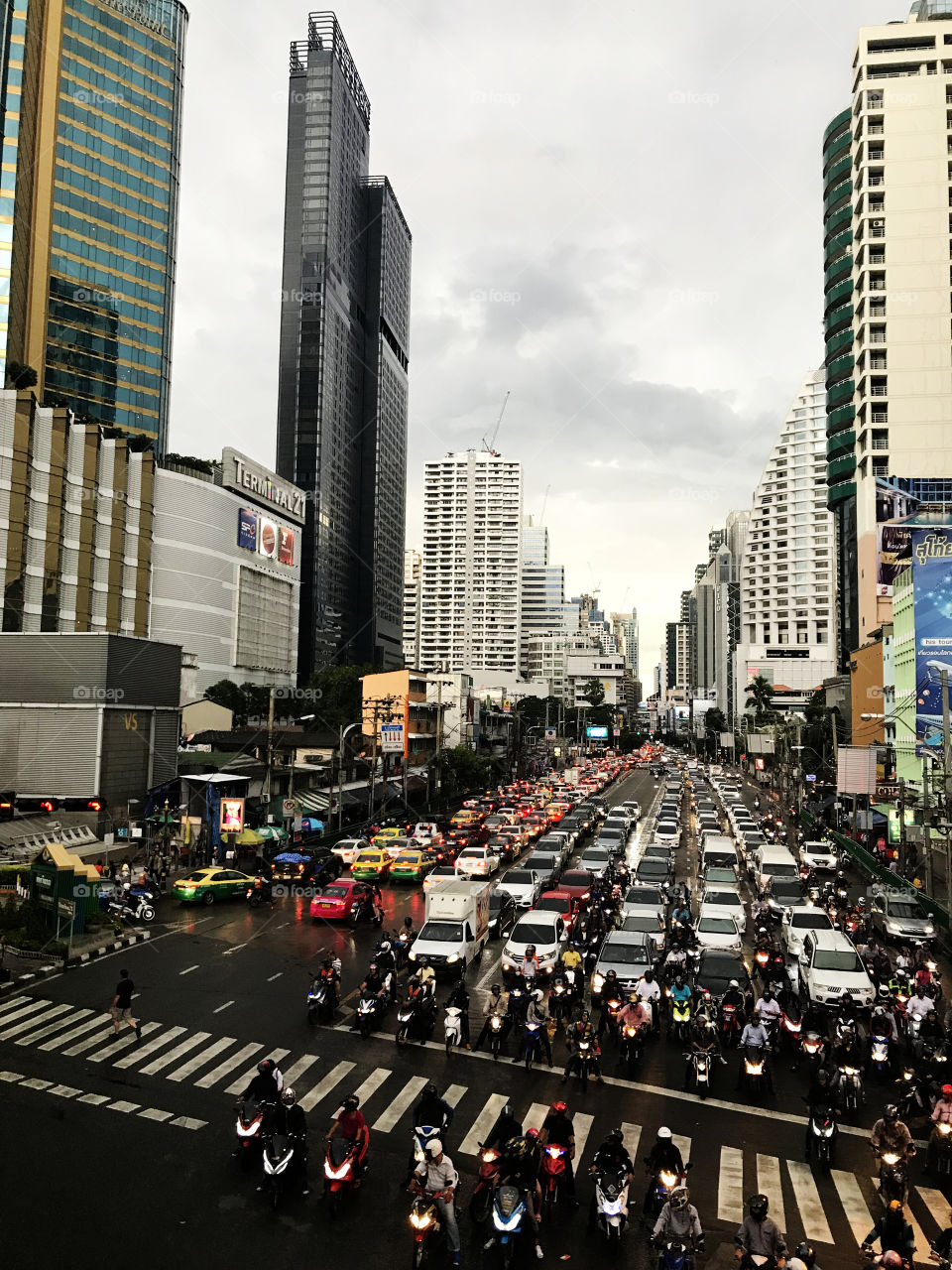 Big cross and crowded calls Asoke on Sukhumvit Rd, Bangkok, Thailand. Narrow  perspective and what' s that line of traffic!