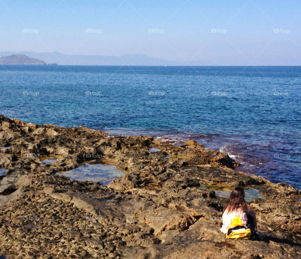 people water sea rocks by n.angelakis