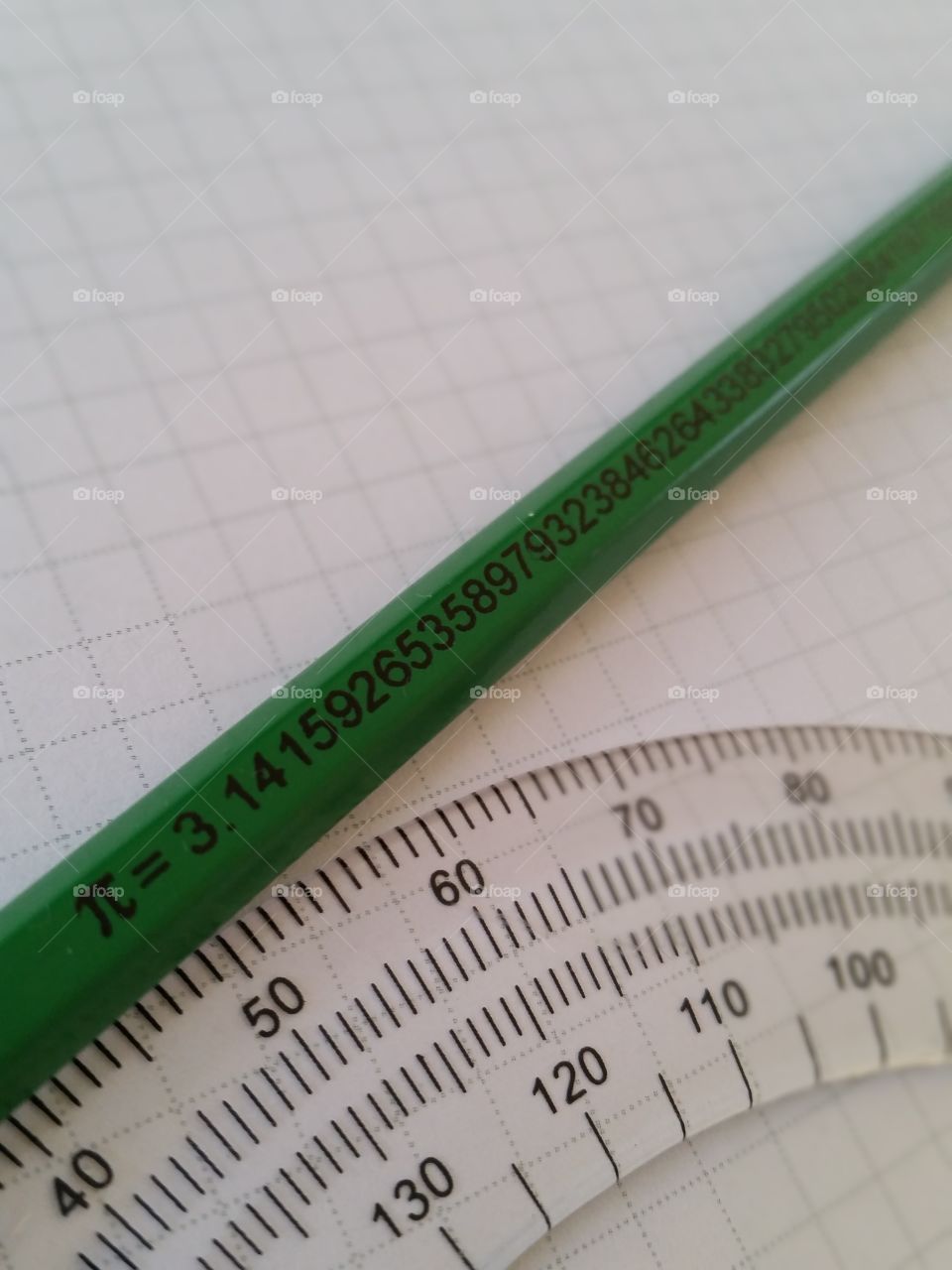 pencil with pi 3.14 on graph paper