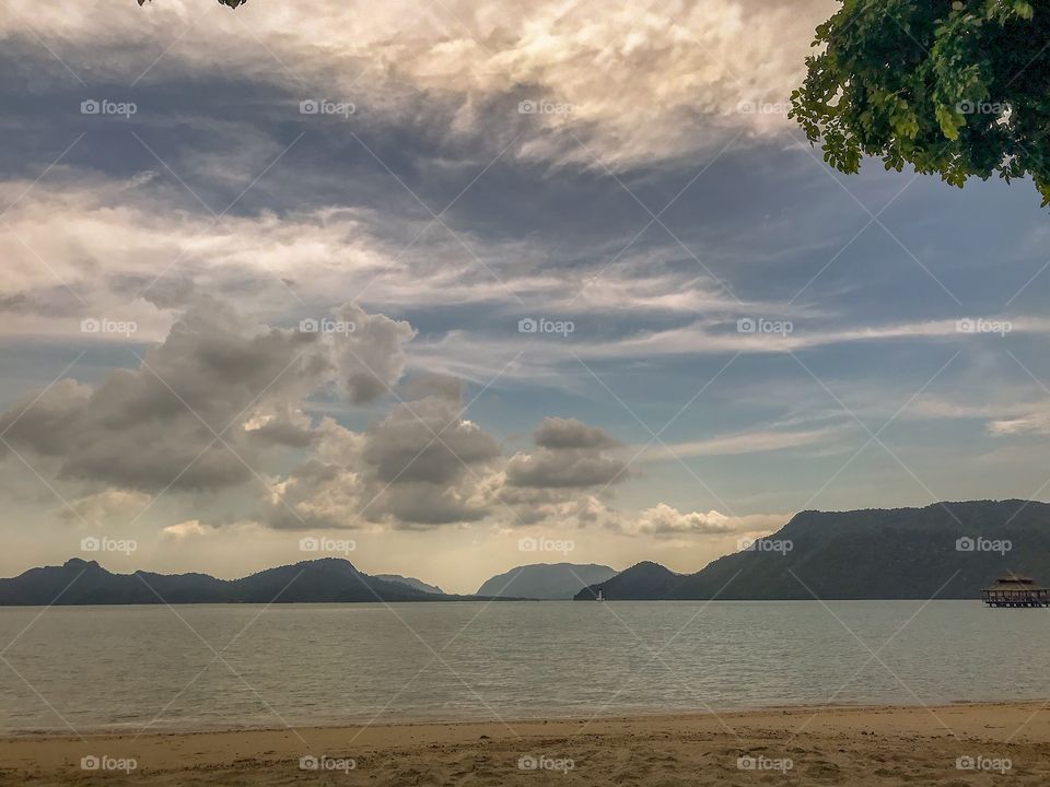 Mountains & beachside view with clouds 
