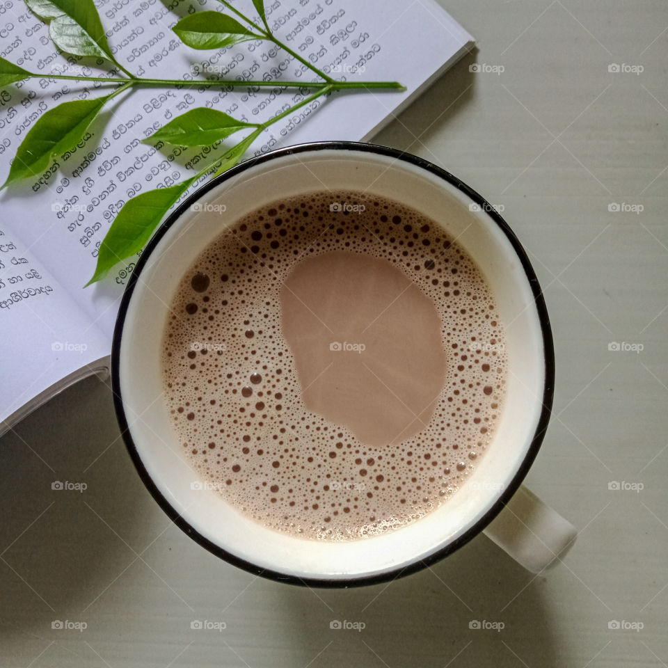 hot chocolate milk drink in a mug isolated on white background , top view .