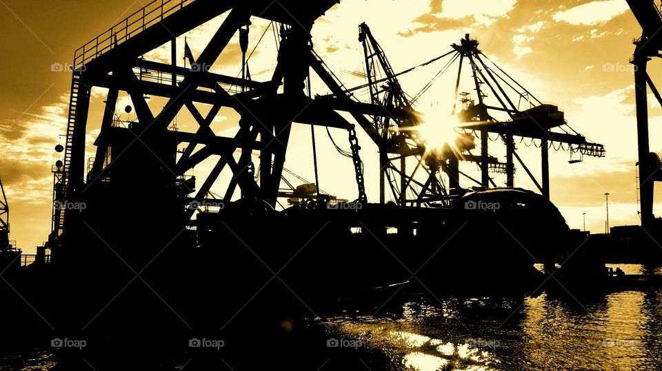 Backlit dredge at container terminal
