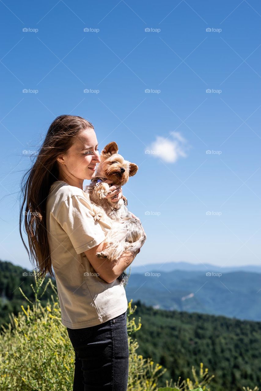 happy caucasian woman in mountain with her dog