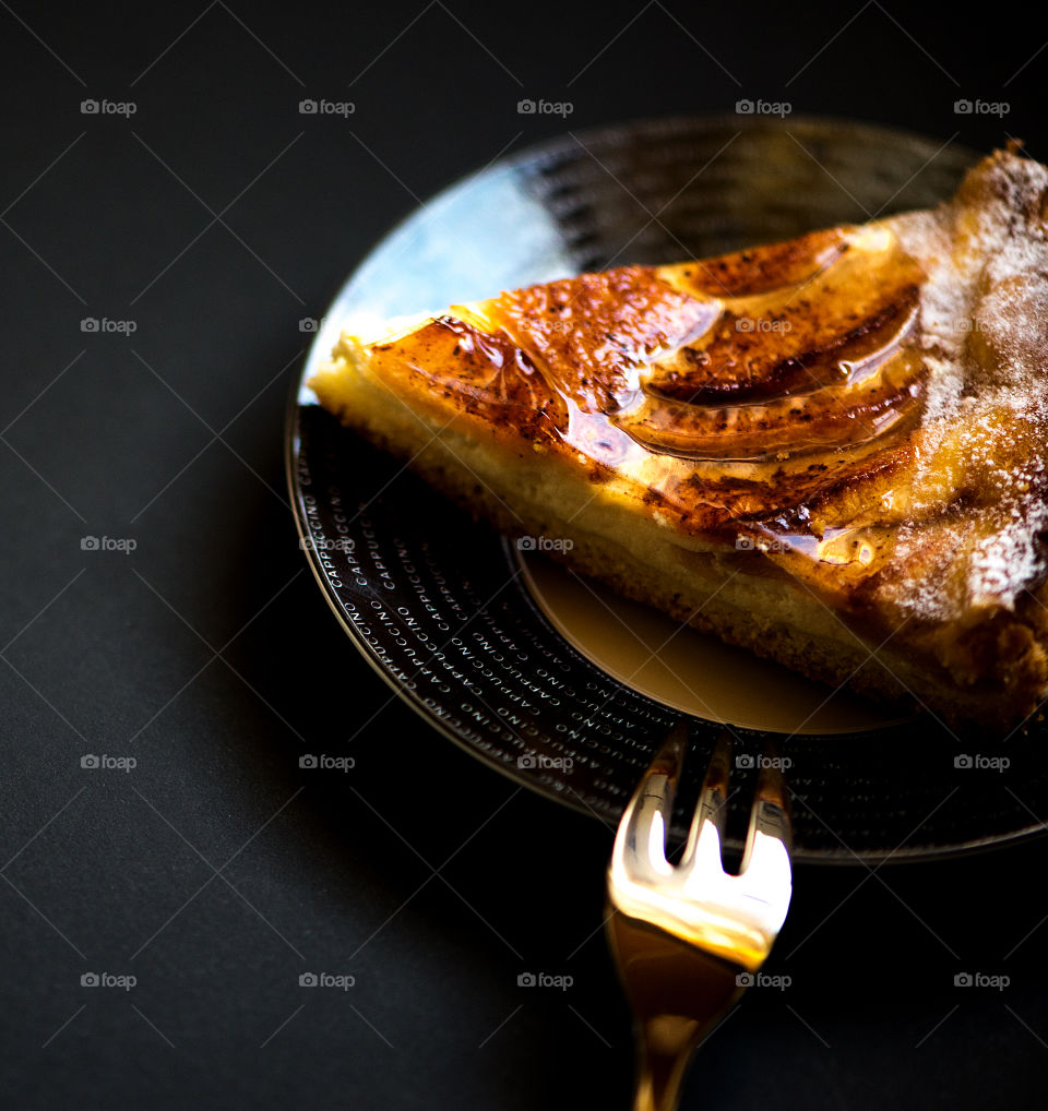 Slice of apples pie isolated on black