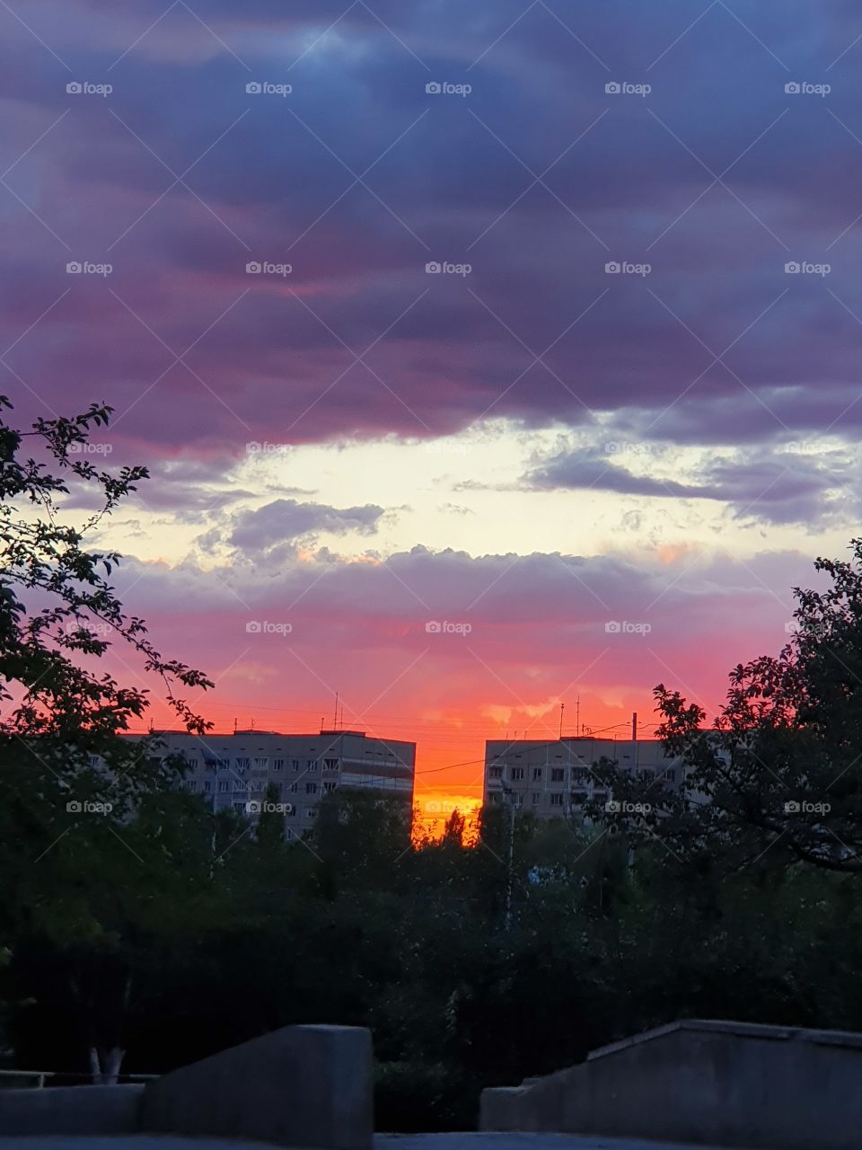 moody urban sunset hiding behind buildings