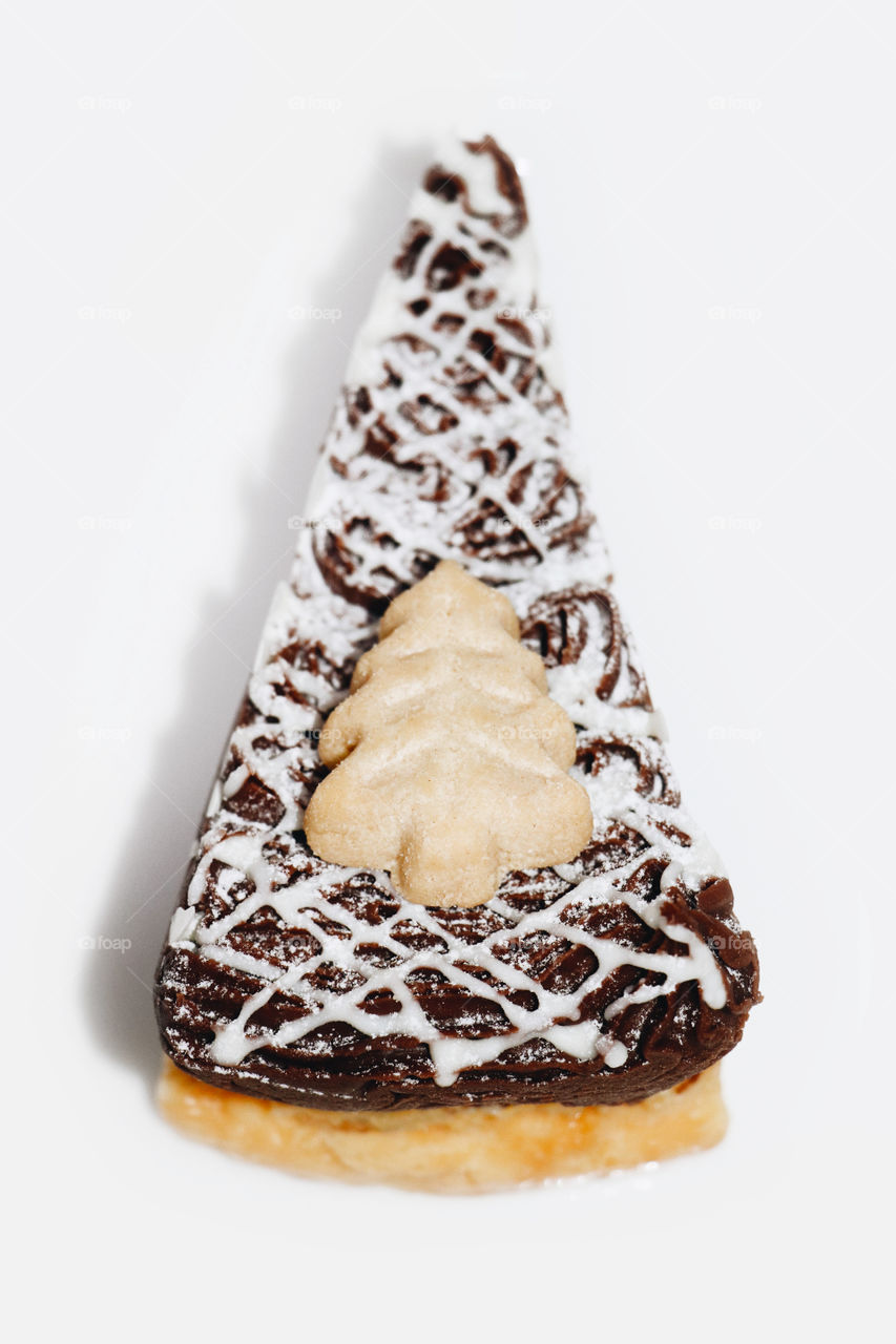 Shortbread Christmas tree with chocolate brownie cheesecake on a white background 