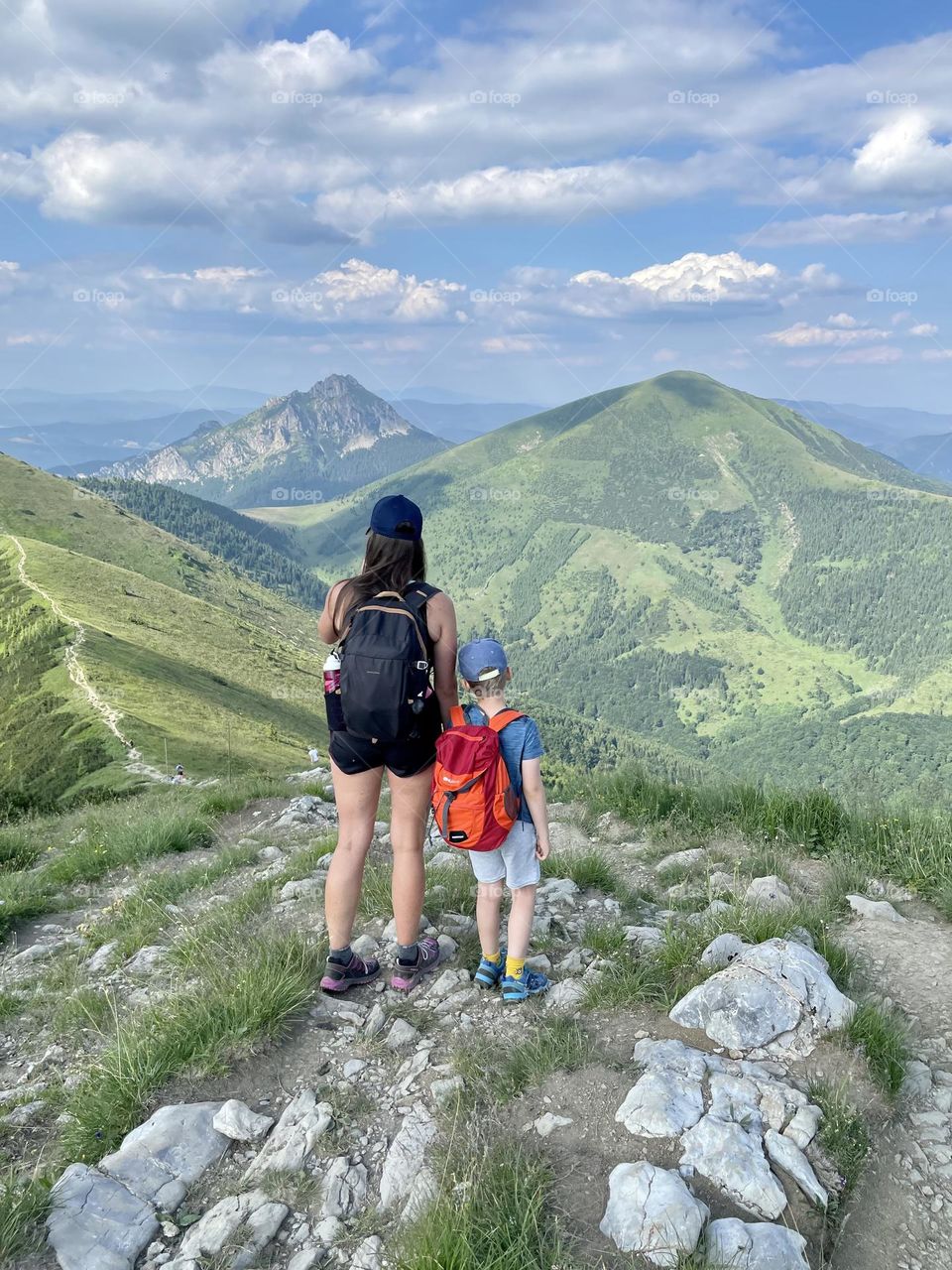 Mother and son reaching on a trail 