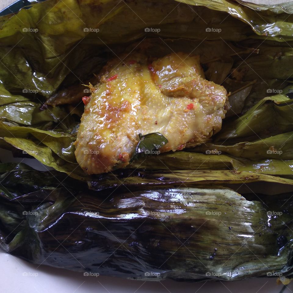 Steamed chicken wrapped in banana leaves