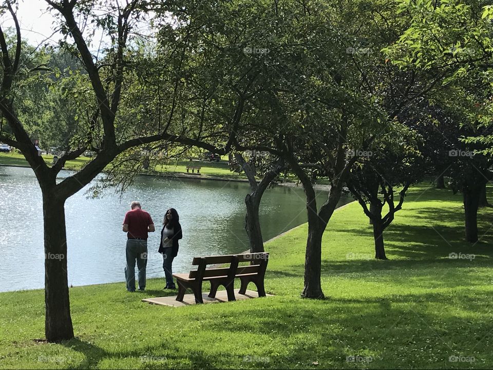Couple standing at lake in the park