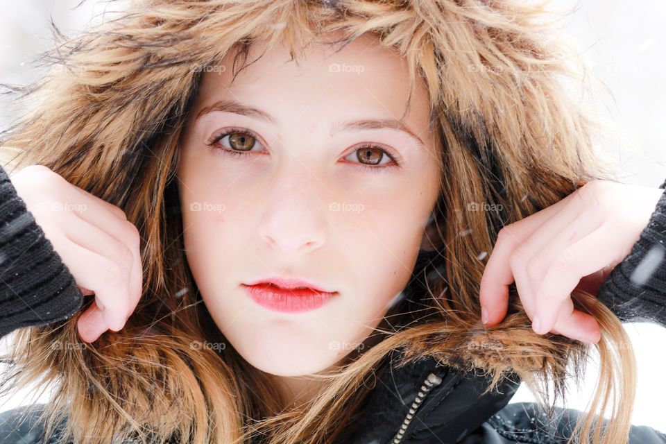 Close-up of young girl with fur cap