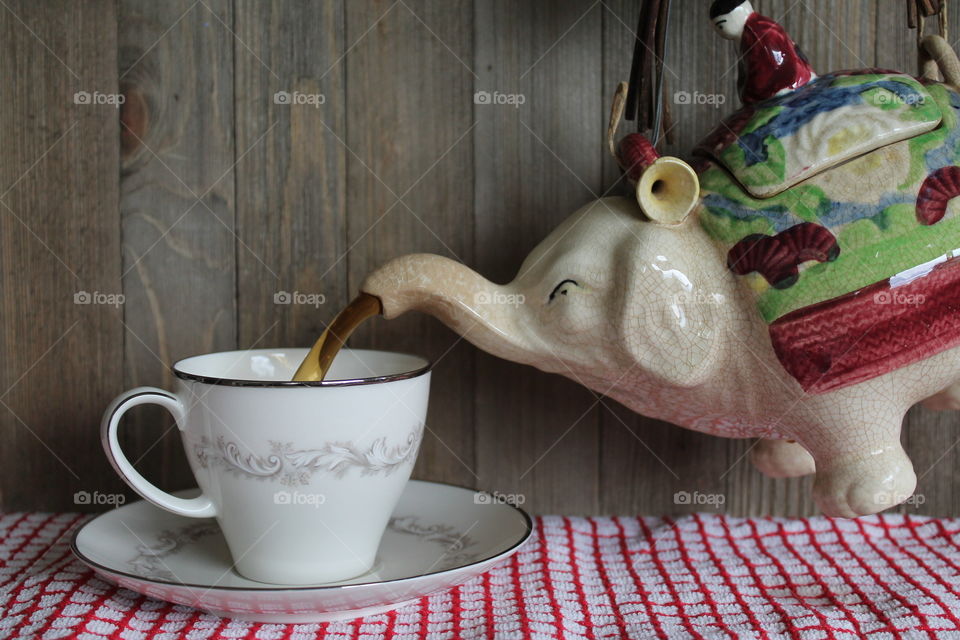 Tea being poured in cup