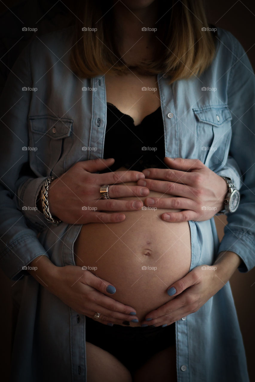 Pregnant couple with belly showing 