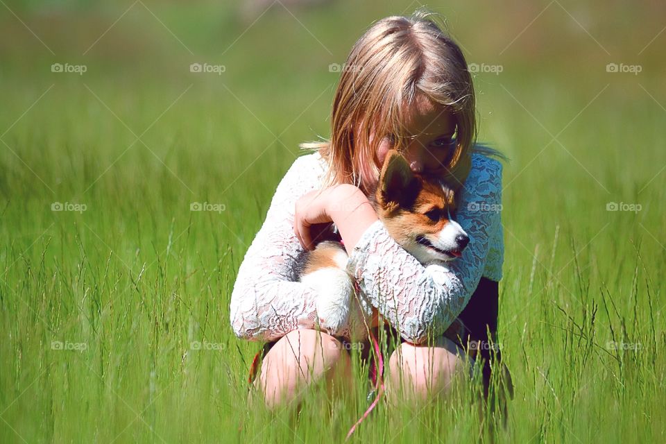 Girl hugging her puppy