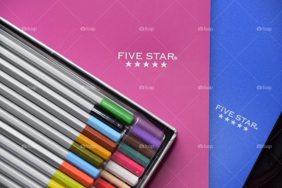 Five star spiral notebook and three ring binder Blue and magenta with colored pencils