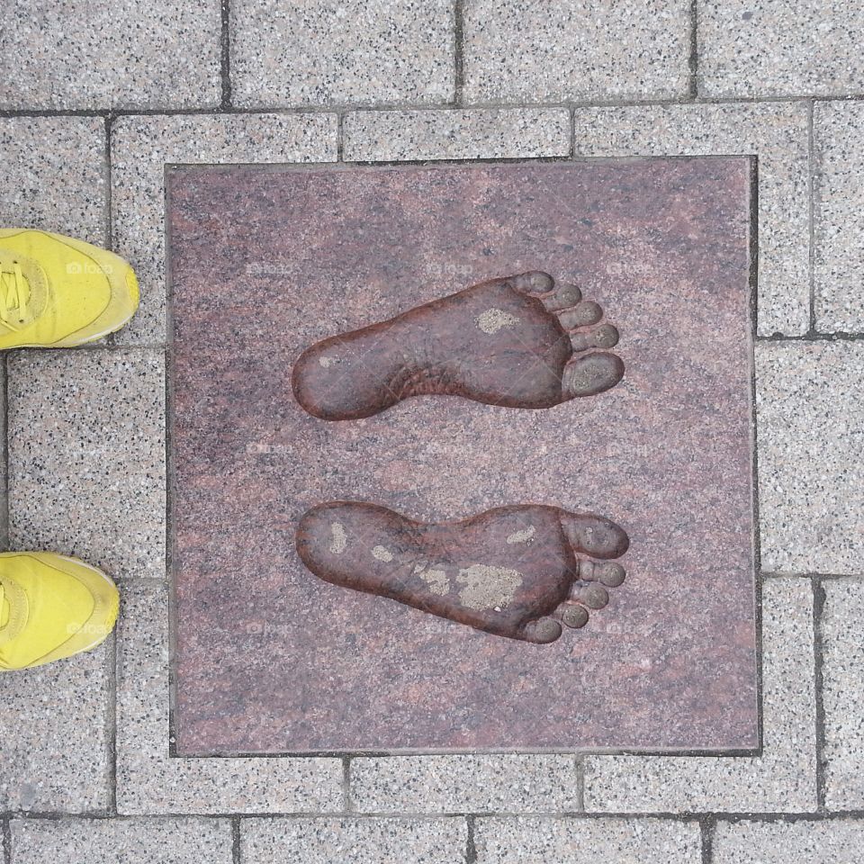 Top view of a foot with footprints