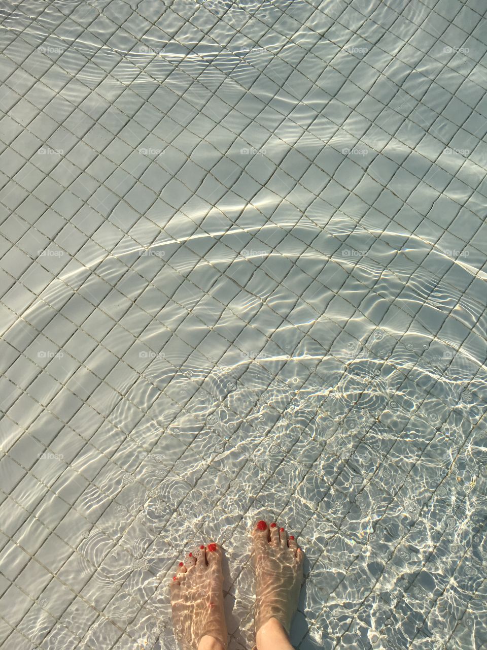 Cooling off and making waves. Getting in the pool on a hot day in the sunshine. 