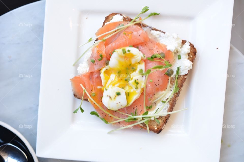 Salmon ricotta poached egg toast. Smoked salmon, ricotta, and poached egg on toast