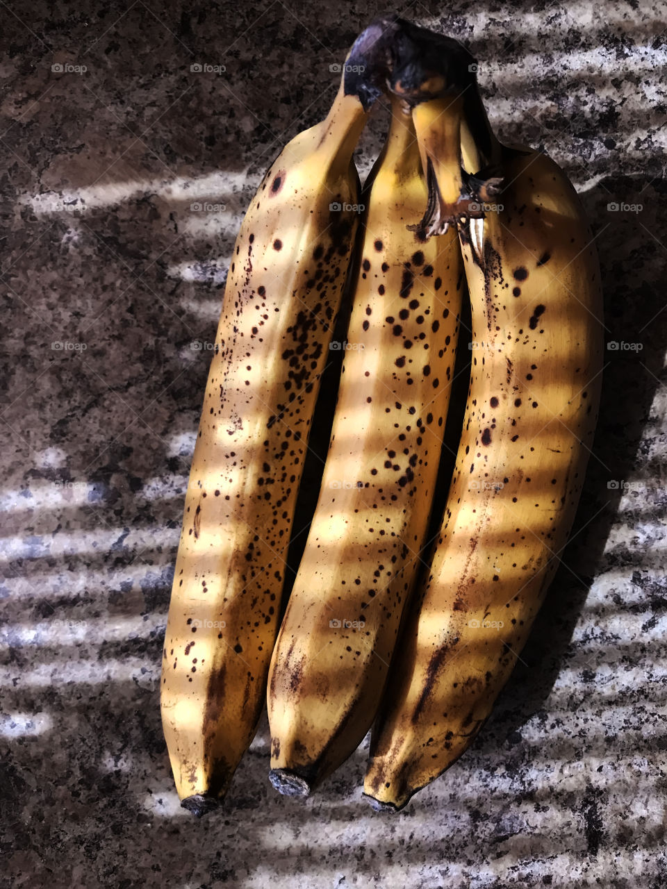 Three bananas in light and shadows 