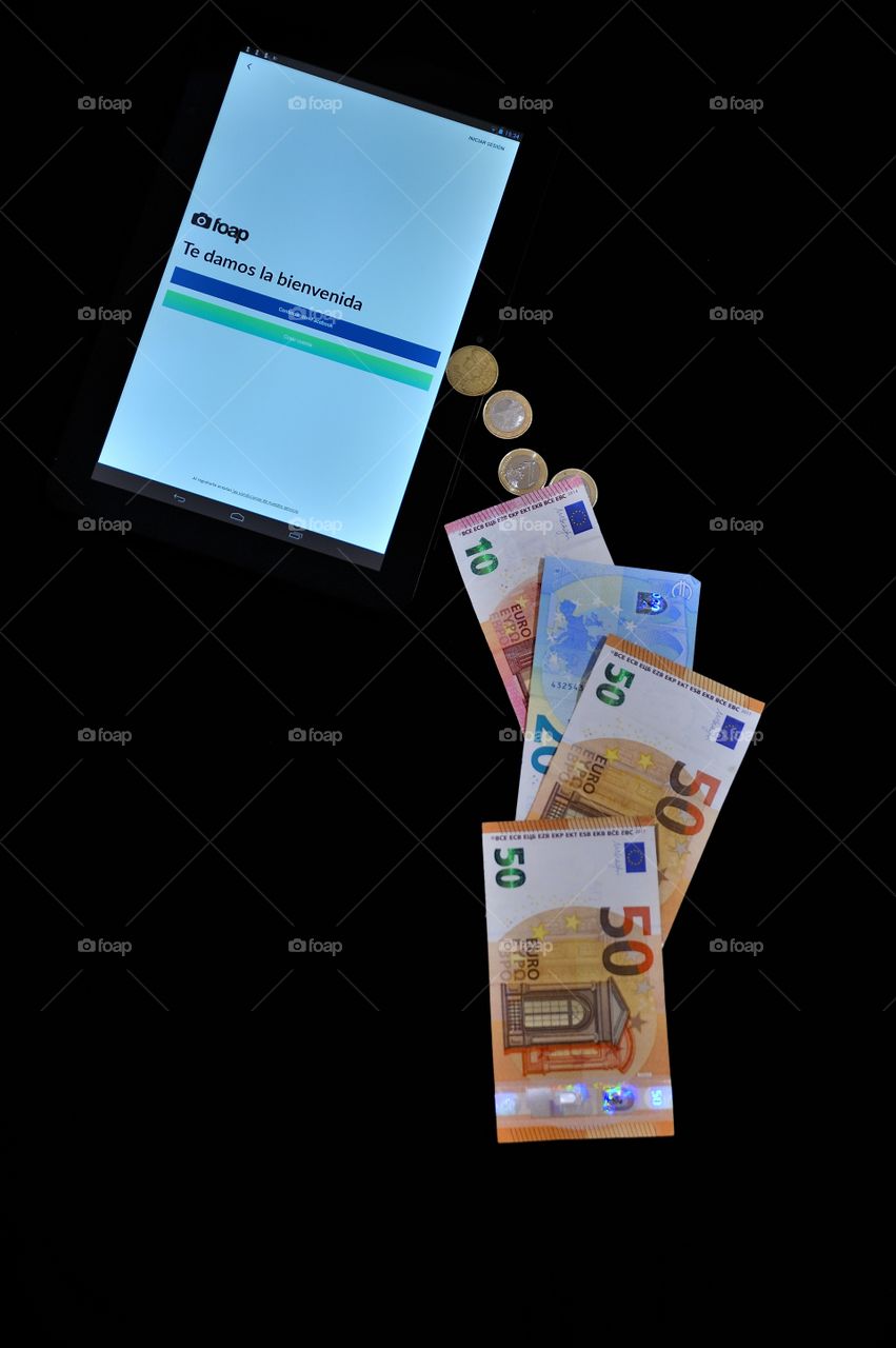 A tablet showing Foap welcome page with a tile of money in euros falling from it.