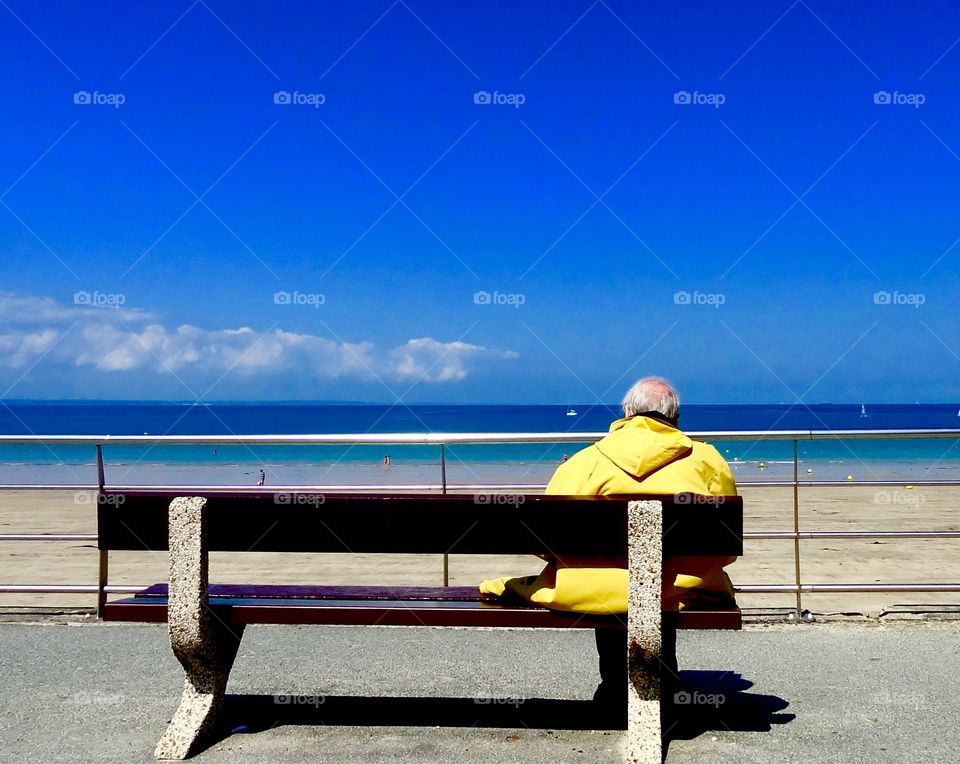 Senior man sitting the sun at beach