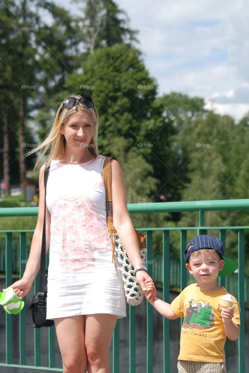 Mother holding hand of her son