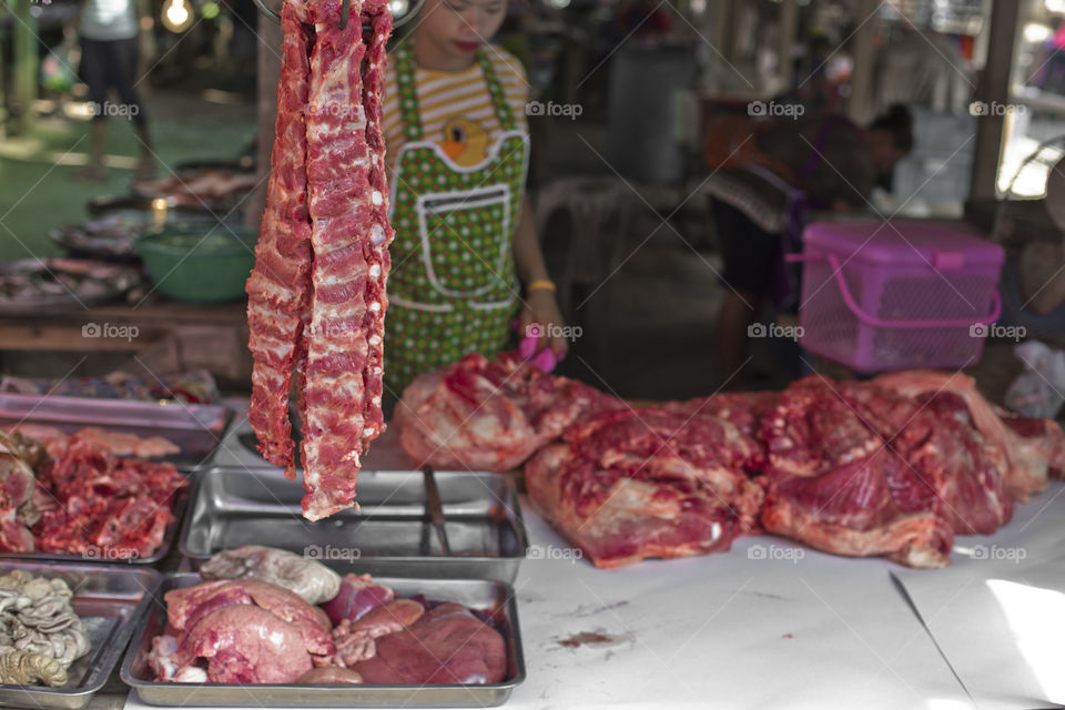 Butcher selling meat at the local market