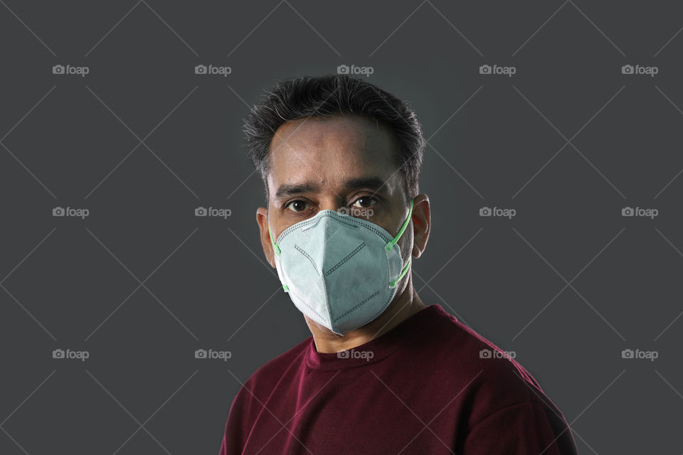 Indian man wearing a face mask, protection against Coronavirus