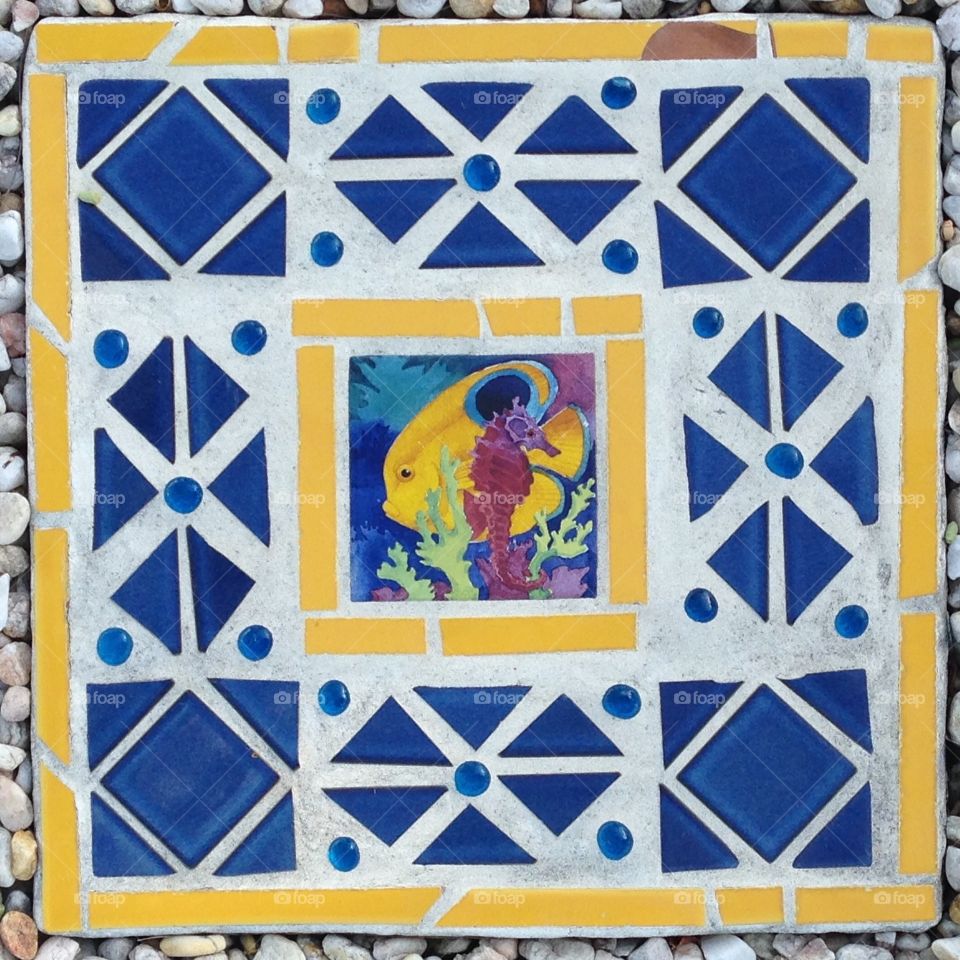 Yellow fish and seahorse mosaic stepping stone