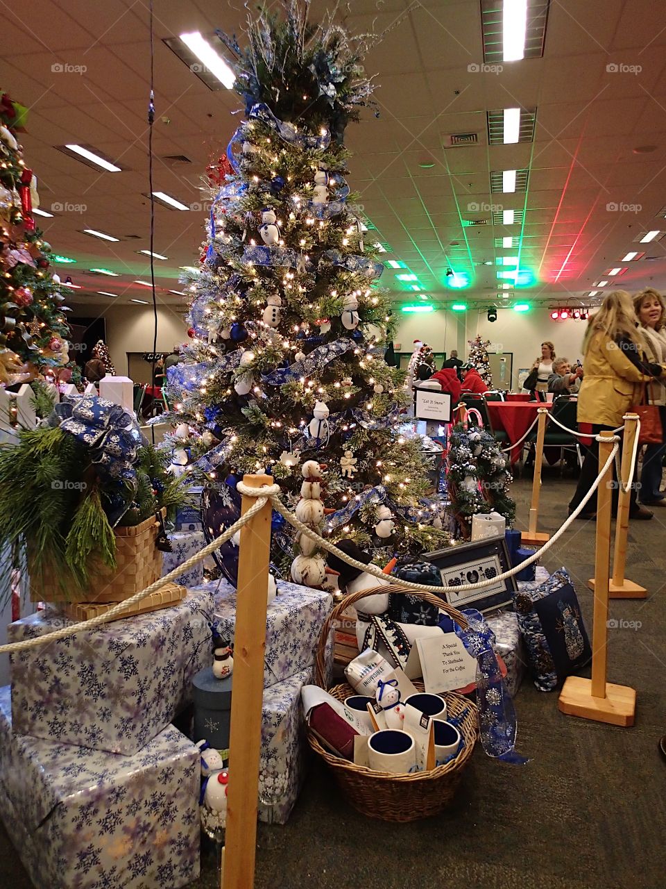 People enjoying some of the beautifully decorated Christmas trees at the annual Central Oregon Festival of Trees fundraising event during the holiday season. 