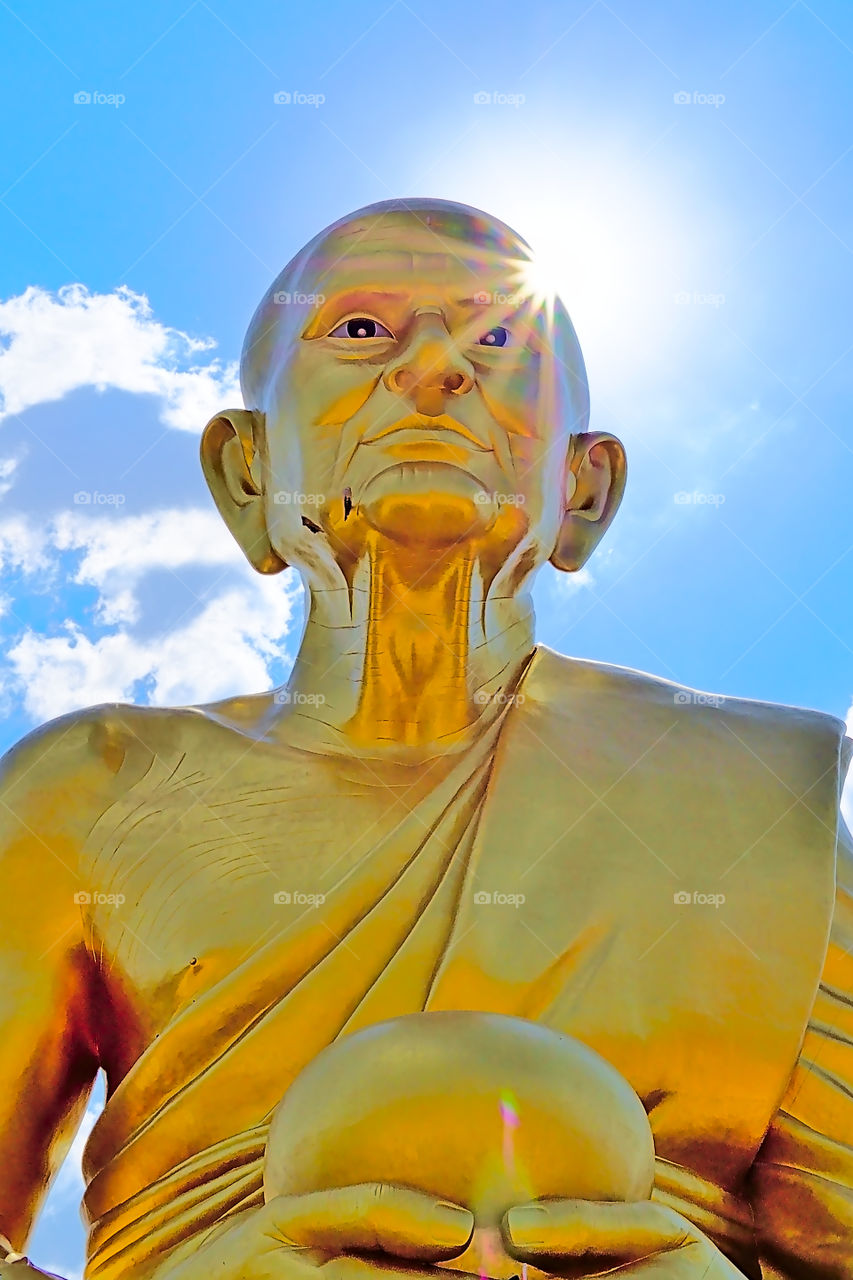 Gigantic buddhist monk golden statue