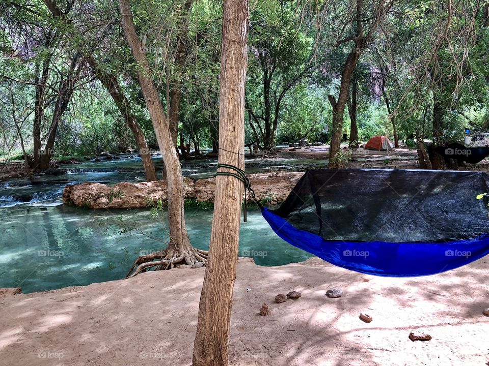 Camping in a hammock down by the crystal clear river and staying far from other campers