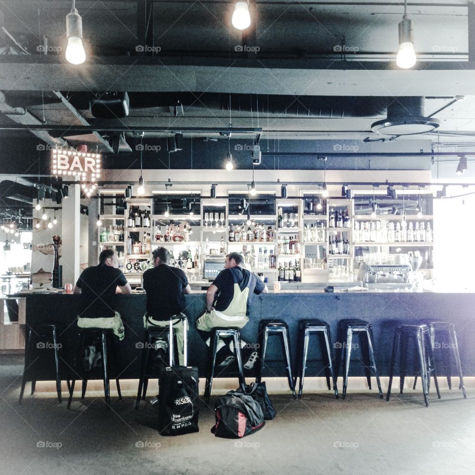 three men in a hotel bar