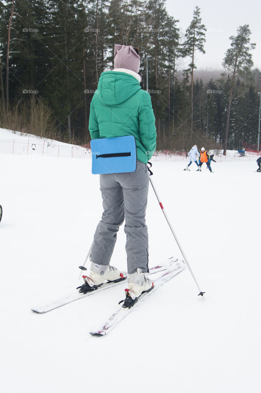 girl is preparing to move down the mountain on skis