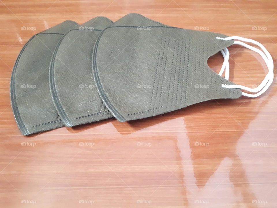 a display of brown masks on ceramic with brown wooden nuances