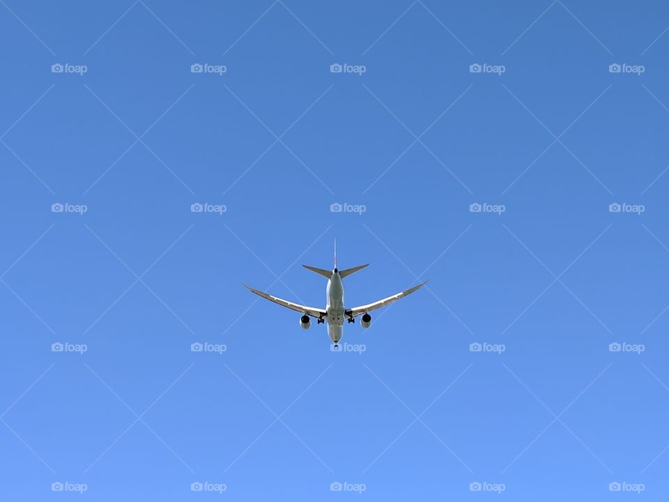plane flying overhead landing at the local Airport
