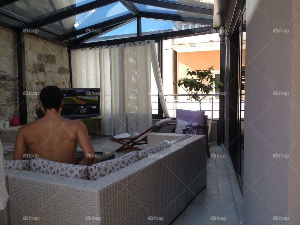 View on balcony. Watching tv on a balcony